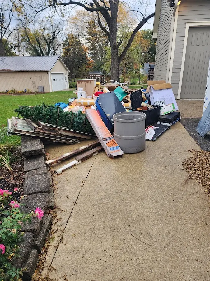 Dumpster being loaded with debris for 3 Yard Dumpster Rental in Pelham